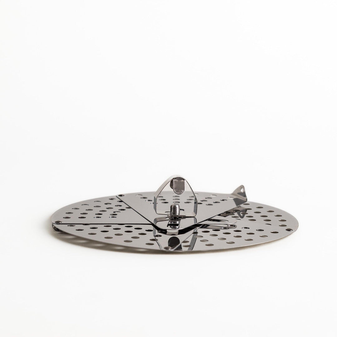 Adjustable stainless steel drop lid, a versatile kitchenware tool with foldable petals for steaming, simmering, and preventing boil-overs in various pot sizes.