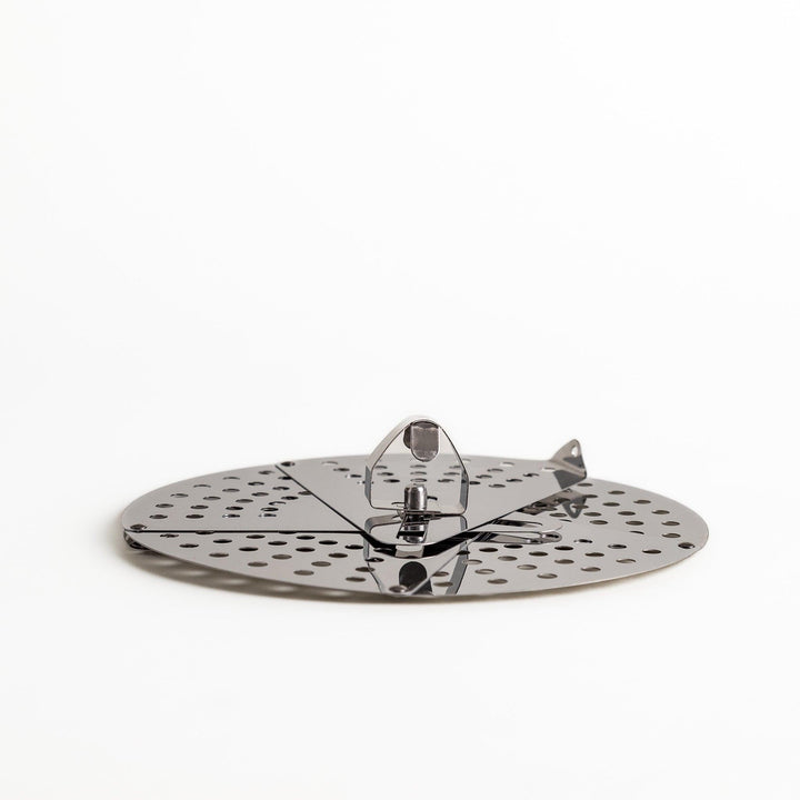 Adjustable stainless steel drop lid, a versatile kitchenware tool with foldable petals for steaming, simmering, and preventing boil-overs in various pot sizes.