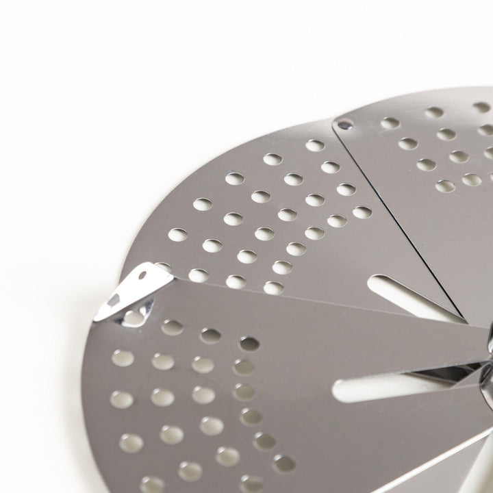 Adjustable stainless steel drop lid, a versatile kitchenware tool with foldable petals for steaming, simmering, and preventing boil-overs in various pot sizes.
