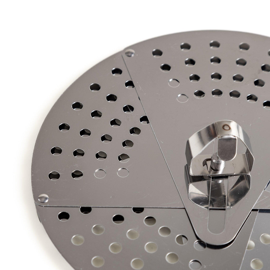 Adjustable stainless steel drop lid, a versatile kitchenware tool with foldable petals for steaming, simmering, and preventing boil-overs in various pot sizes.