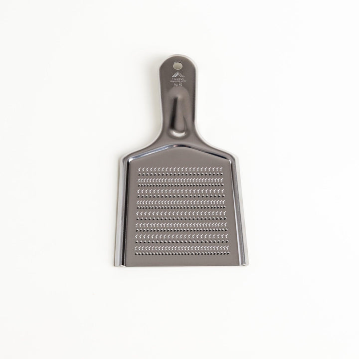 Durable stainless steel grater with sharp blades and an ergonomic handle, a versatile kitchenware tool for grating cheese, vegetables, and spices.
