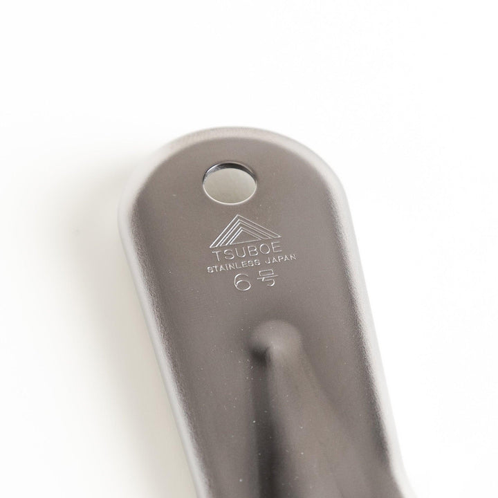 Durable stainless steel grater with sharp blades and an ergonomic handle, a versatile kitchenware tool for grating cheese, vegetables, and spices.