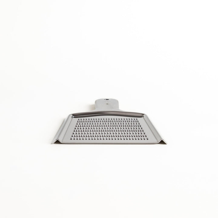 Durable stainless steel grater with sharp blades on both sides, a versatile kitchenware tool for efficiently grating vegetables, cheese, and other ingredients.