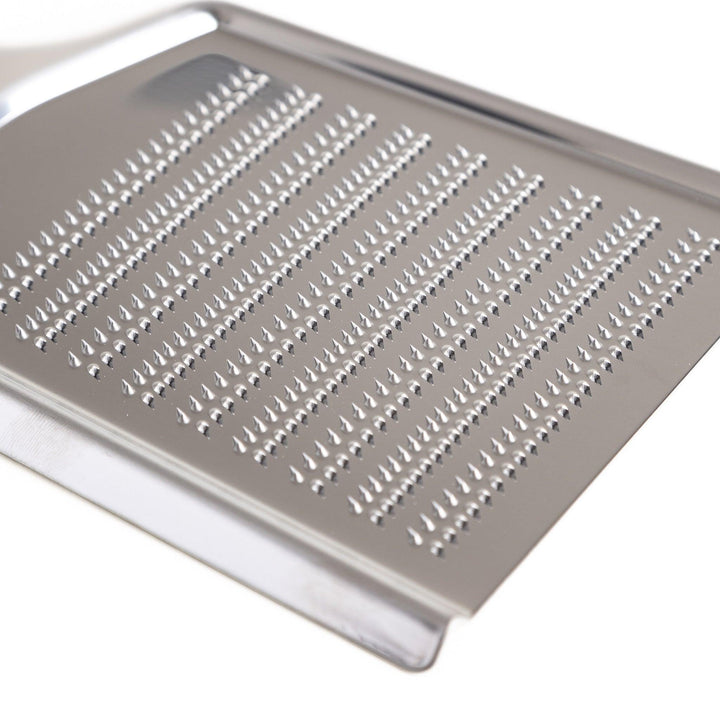 Durable stainless steel grater with sharp blades on both sides, a versatile kitchenware tool for efficiently grating vegetables, cheese, and other ingredients.