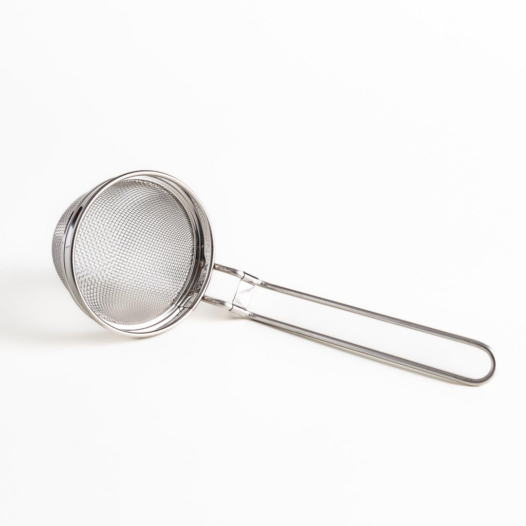 Stainless steel miso strainer with a fine mesh and a long handle, a handy kitchenware tool for straining miso paste and making smooth miso soup.
