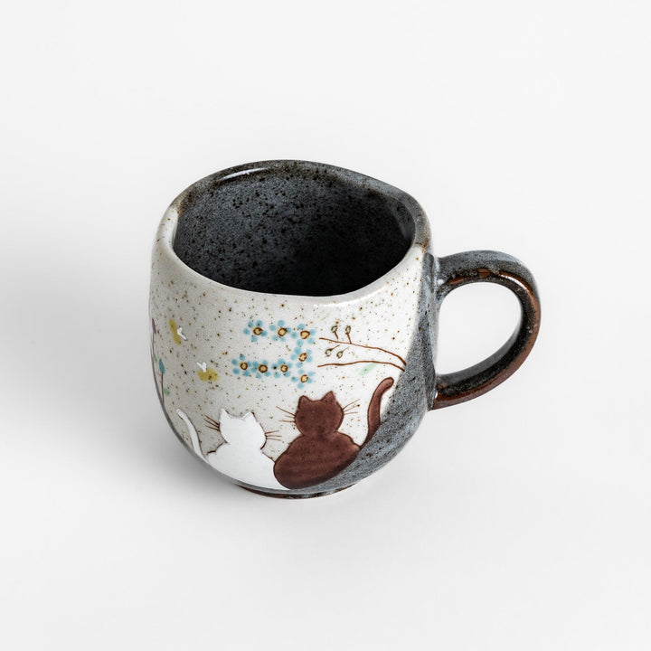 Charming Mug featuring two cats sitting together, surrounded by blooming flowers and birds.