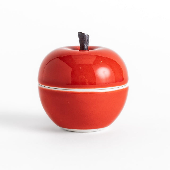 Red Apple Lidded Condiment Bowl, a charming apple-shaped ceramic bowl with a glossy red finish and a small black stem, perfect for serving sauces and condiments.