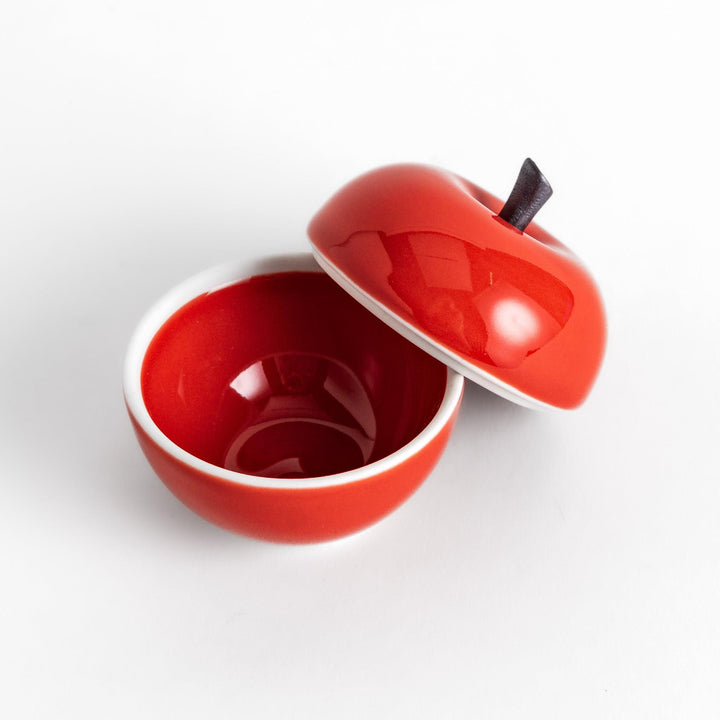 Red Apple Lidded Condiment Bowl, a charming apple-shaped ceramic bowl with a glossy red finish and a small black stem, perfect for serving sauces and condiments.