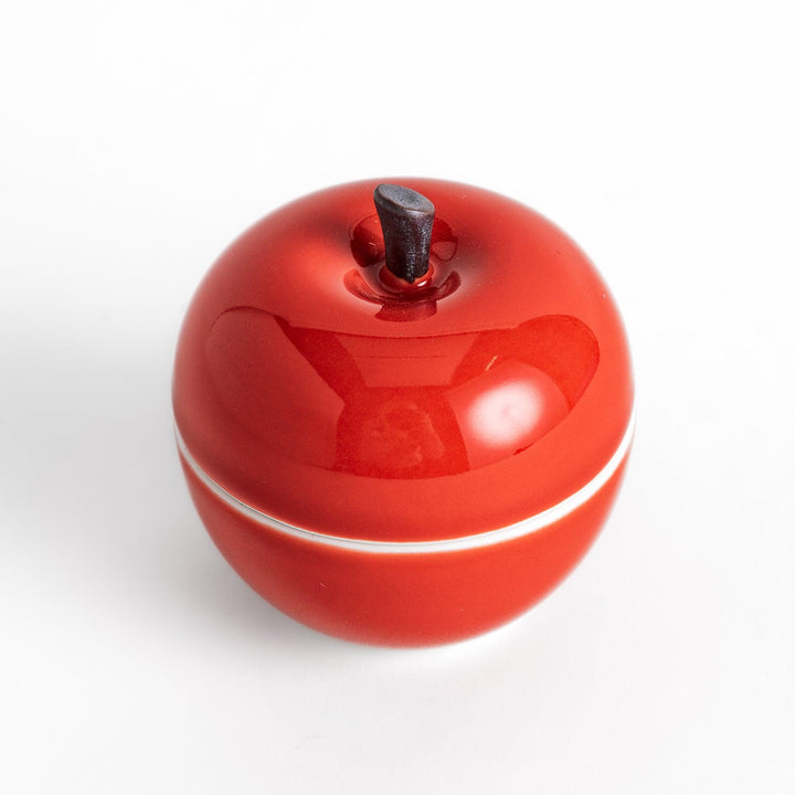 Red Apple Lidded Condiment Bowl, a charming apple-shaped ceramic bowl with a glossy red finish and a small black stem, perfect for serving sauces and condiments.