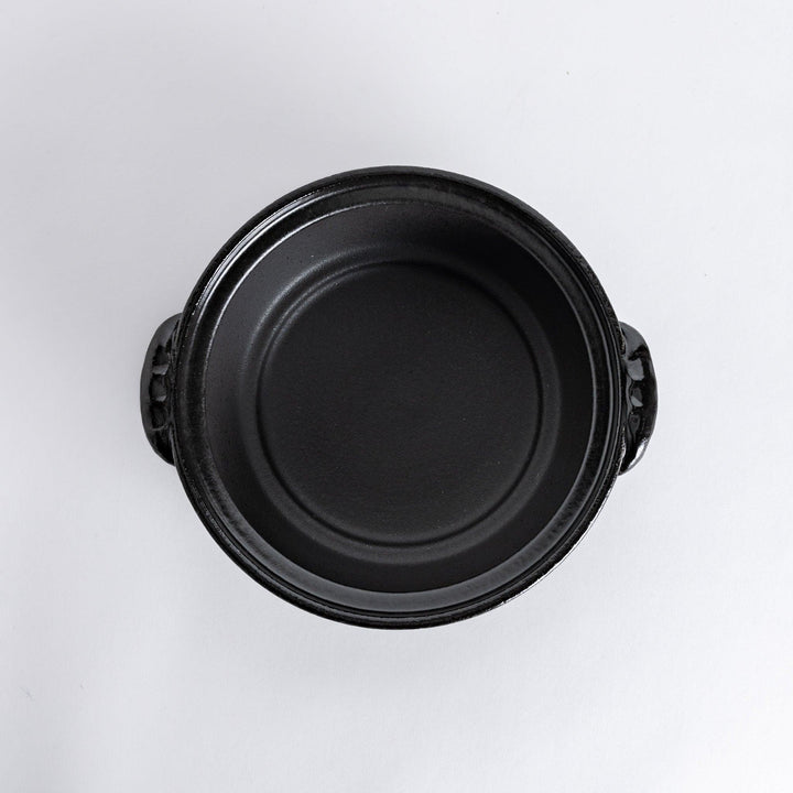 A 8-inch donabe with a vibrant red blossom pattern lid and black pot.