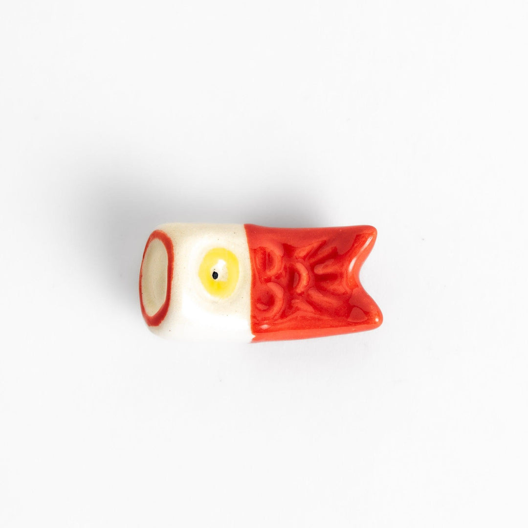 Chopstick rest shaped like a red carp streamer with intricate details and a playful, colorful design.