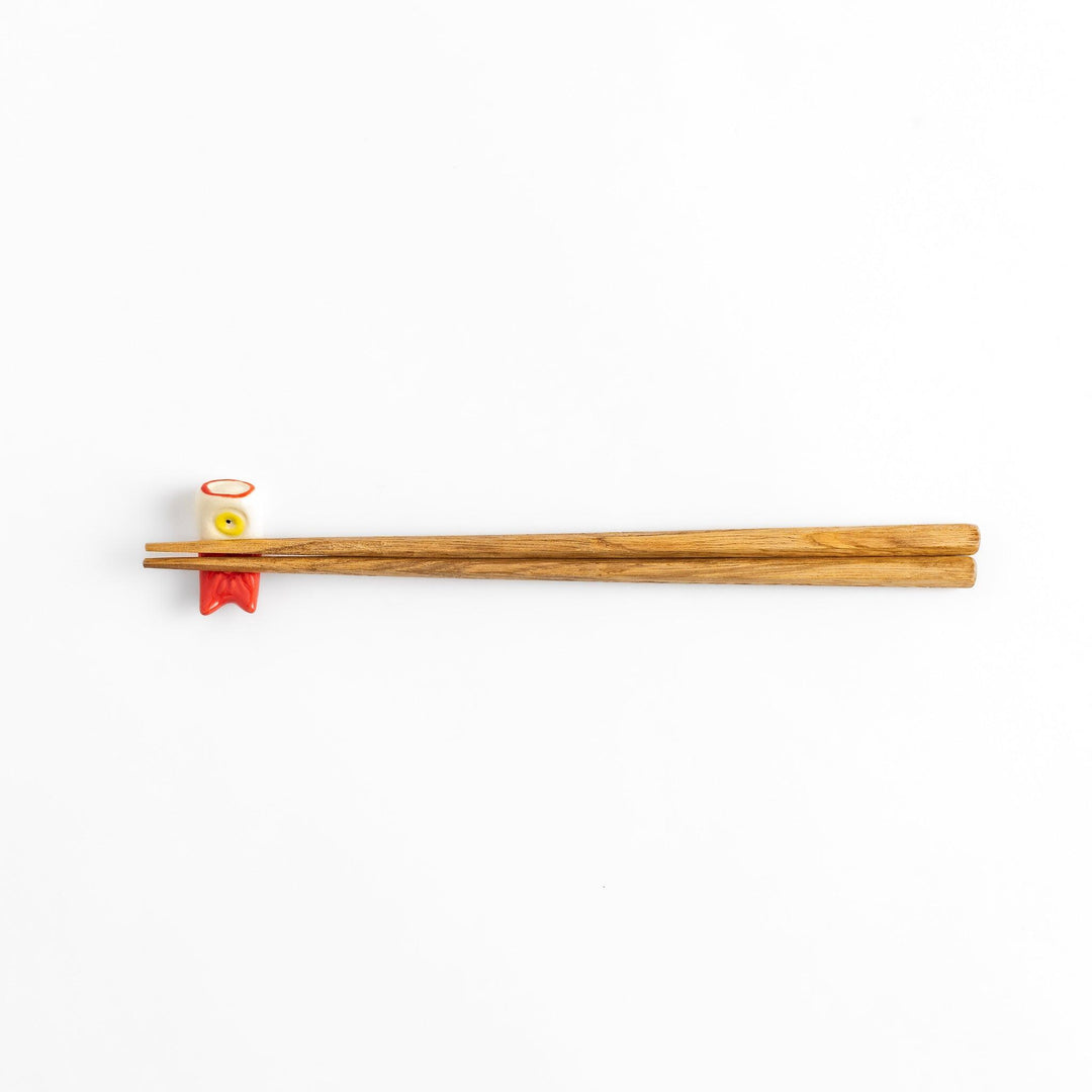 Chopstick rest shaped like a red carp streamer with intricate details and a playful, colorful design.