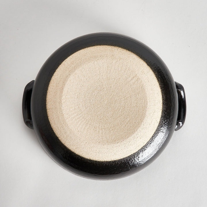 A 8-inch donabe with a vibrant black floral pattern lid and black pot.