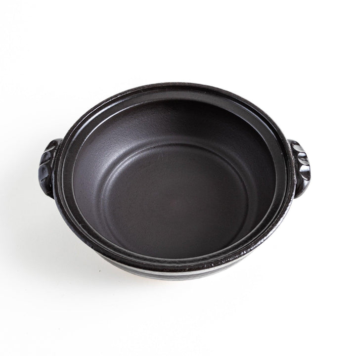 A 8-inch donabe with a vibrant black floral pattern lid and black pot.