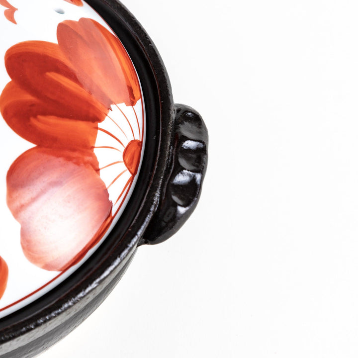 Close-up of handle and floral design, emphasizing craftsmanship and ease of handling for convenient, stylish serving.