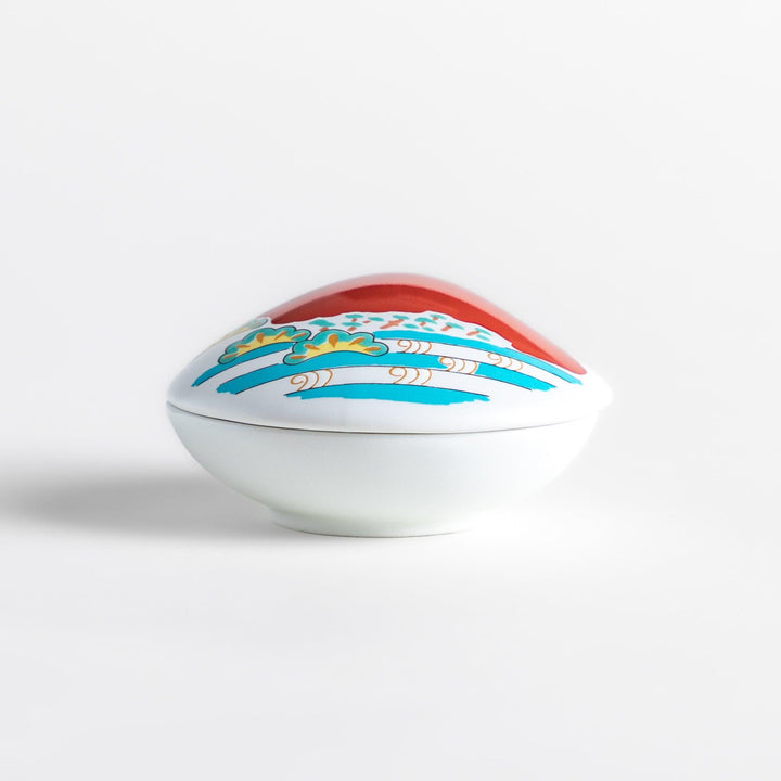 White ceramic incense holder shaped like a seashell, showcasing a striking red Mount Fuji design with golden accents and a secure incense stand inside for refined elegance.