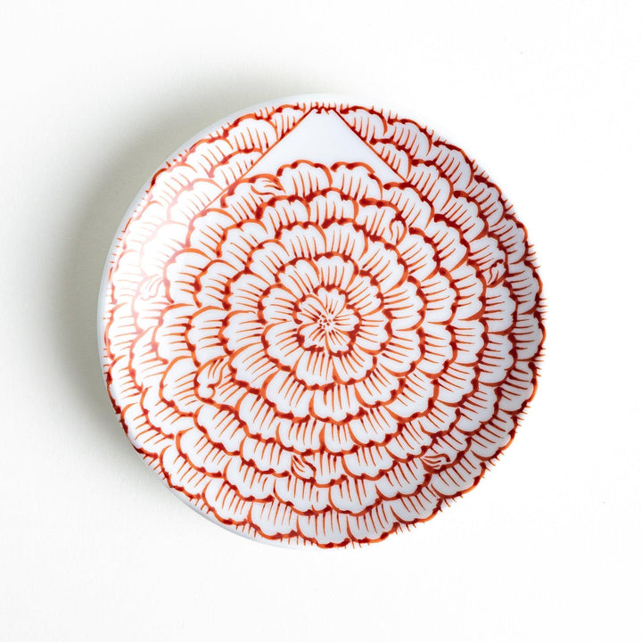 Round plate with a red chrysanthemum petal design.