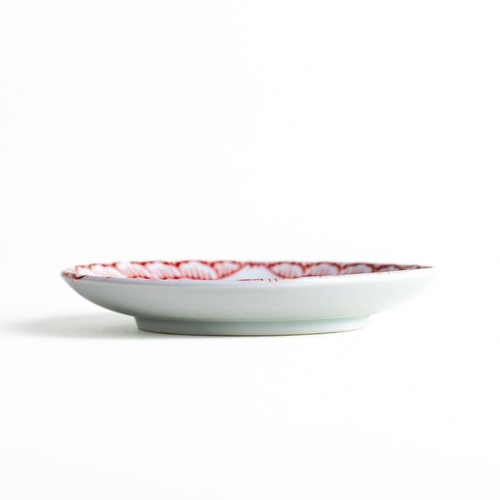 Round plate with a red chrysanthemum petal design.