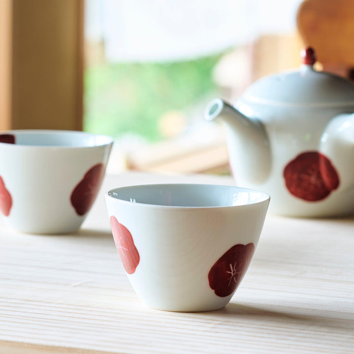 White teacup with a bold red design, offering a stylish and modern touch to your tea-drinking experience.