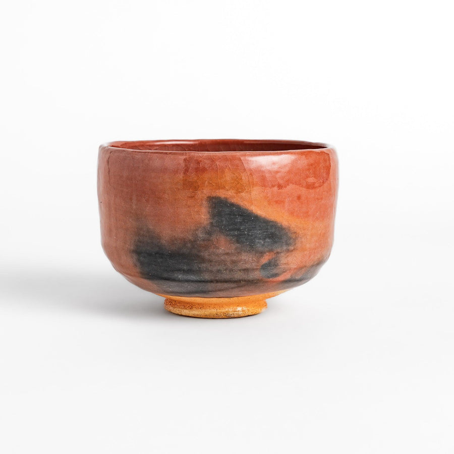 Rustic Raku ware Matcha bowl with a unique textured glaze and a striking black and red design.