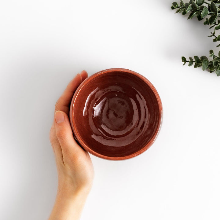 Rustic Raku ware Matcha bowl with a unique textured glaze and a striking black and red design.