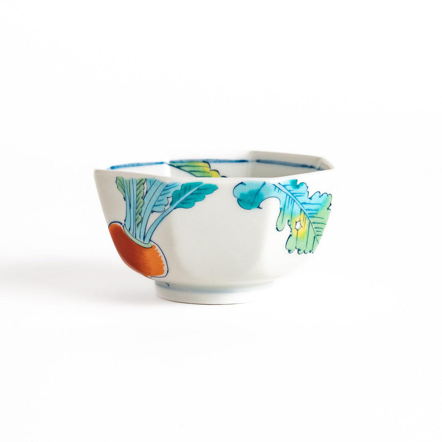 A white porcelain dessert bowl adorned with vibrant illustrations of red turnips and green leaves. Its octagonal shape adds elegance.