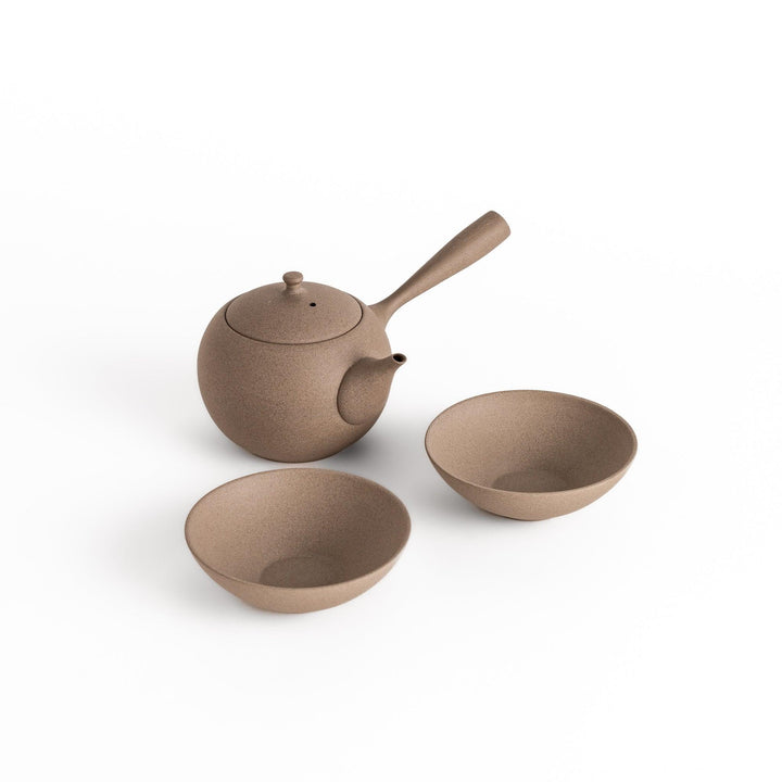 Elegant gray tea set featuring a round teapot with a handle and spout, accompanied by matching round bowls, perfect for a serene tea experience.
