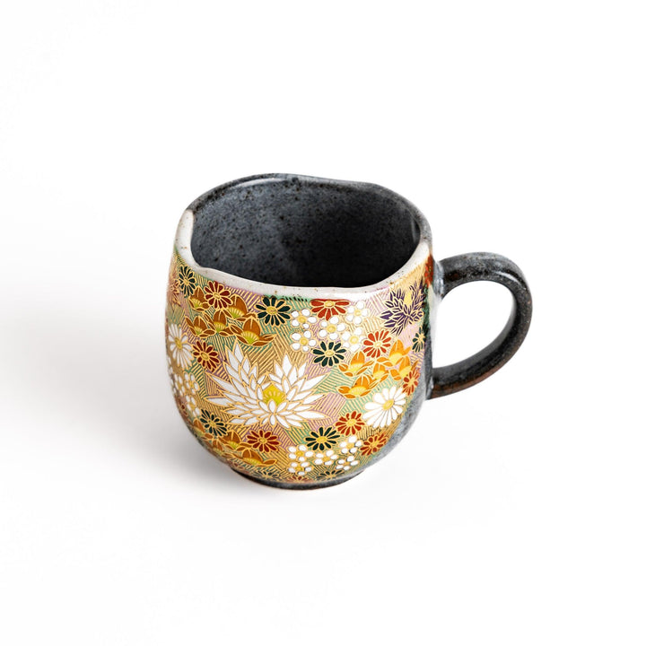 Gray ceramic mug with a vibrant floral pattern in gold and pastel colors, featuring a comfortable handle and a unique speckled glaze.