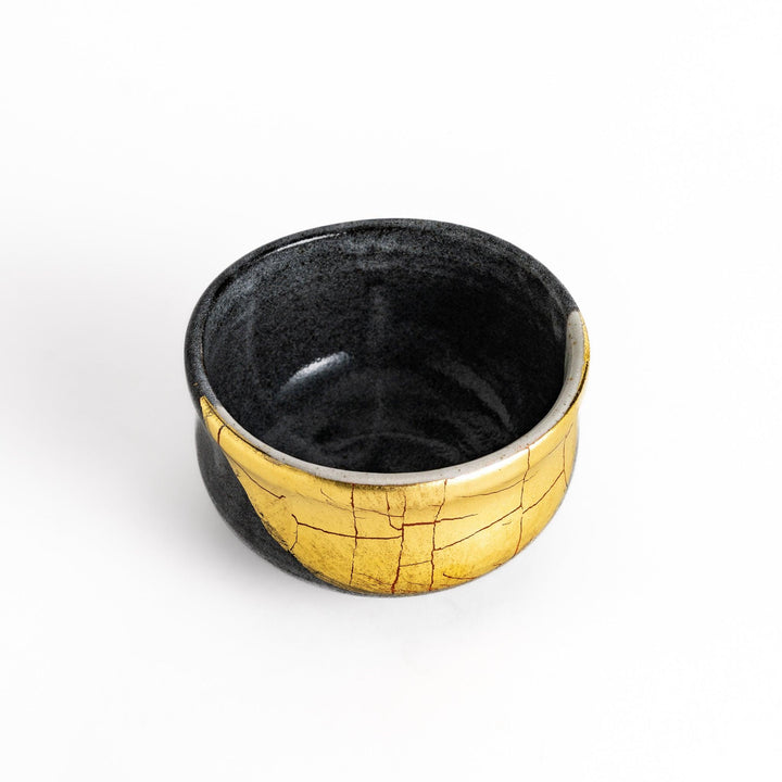 Black matcha bowl with a striking gold crackle effect, adding a touch of elegance to your traditional matcha tea ceremony.