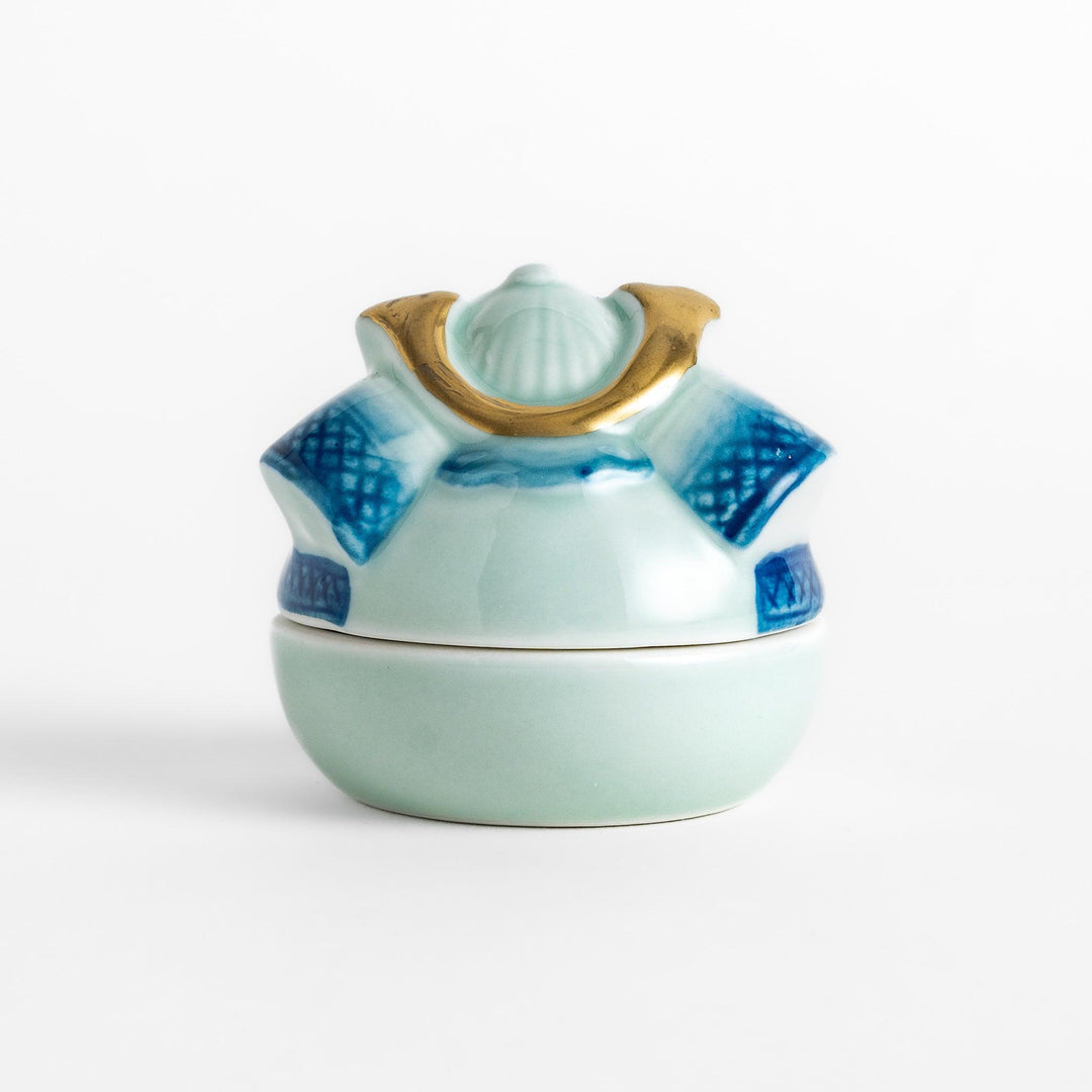 Samurai Helmet Lidded Condiment Bowl, a ceramic bowl with a unique lid shaped like a samurai helmet, featuring intricate blue and gold detailing, perfect for serving sauces.
