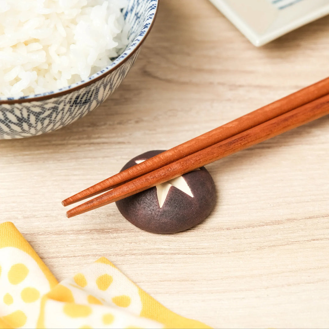 Shiitake mushroom chopstick rest crafted in ceramic, a playful and functional Japanese tableware accent for everyday dining.