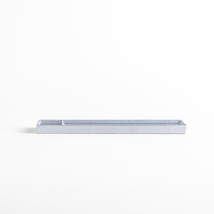 Sleek aluminum incense holder with a modern minimalist design, featuring a rectangular tray and a built-in slot to securely hold incense sticks while catching ash.
