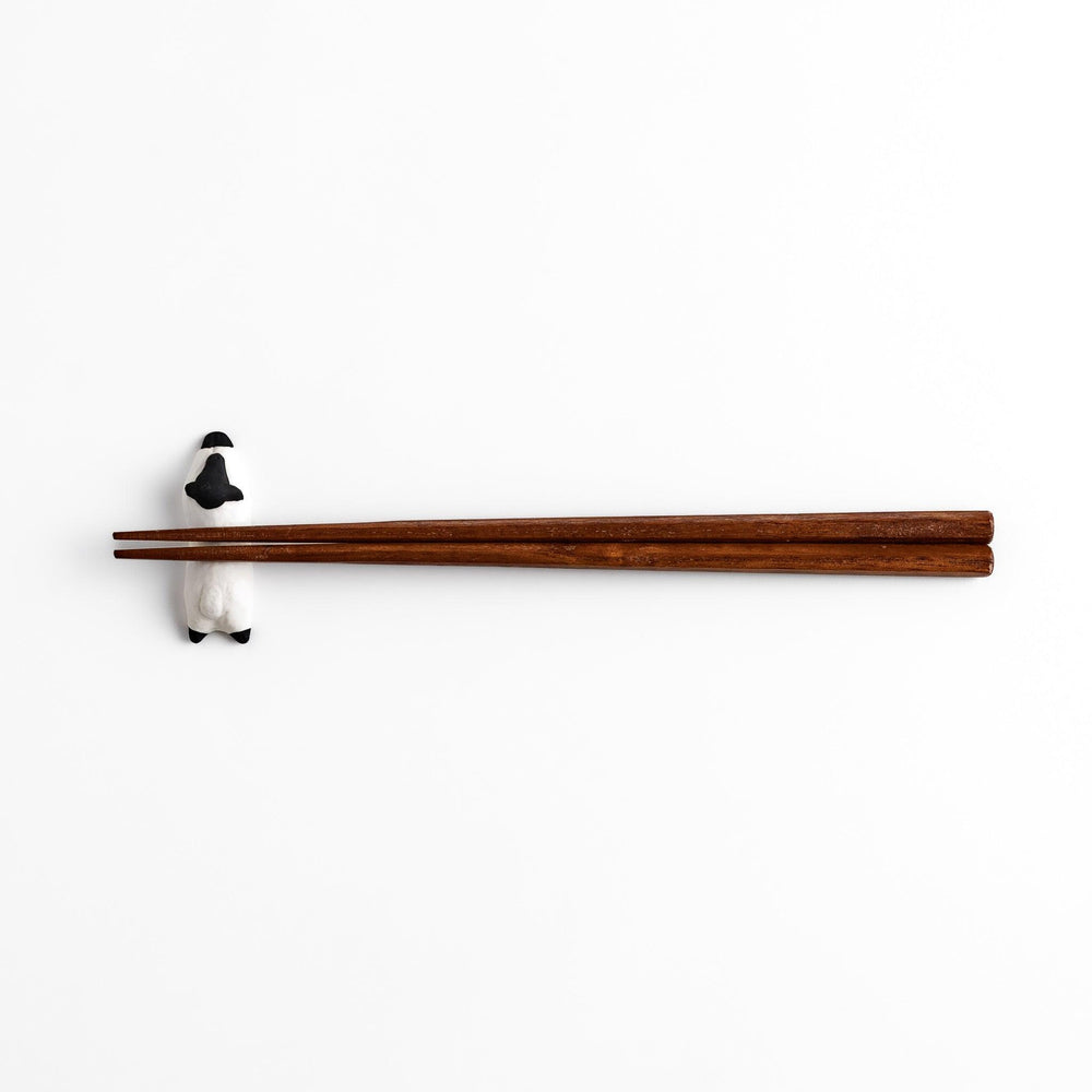 Adorable sleeping sheep chopstick rest, crafted with a minimalist design in black and white, adding a playful and charming touch to your dining table.