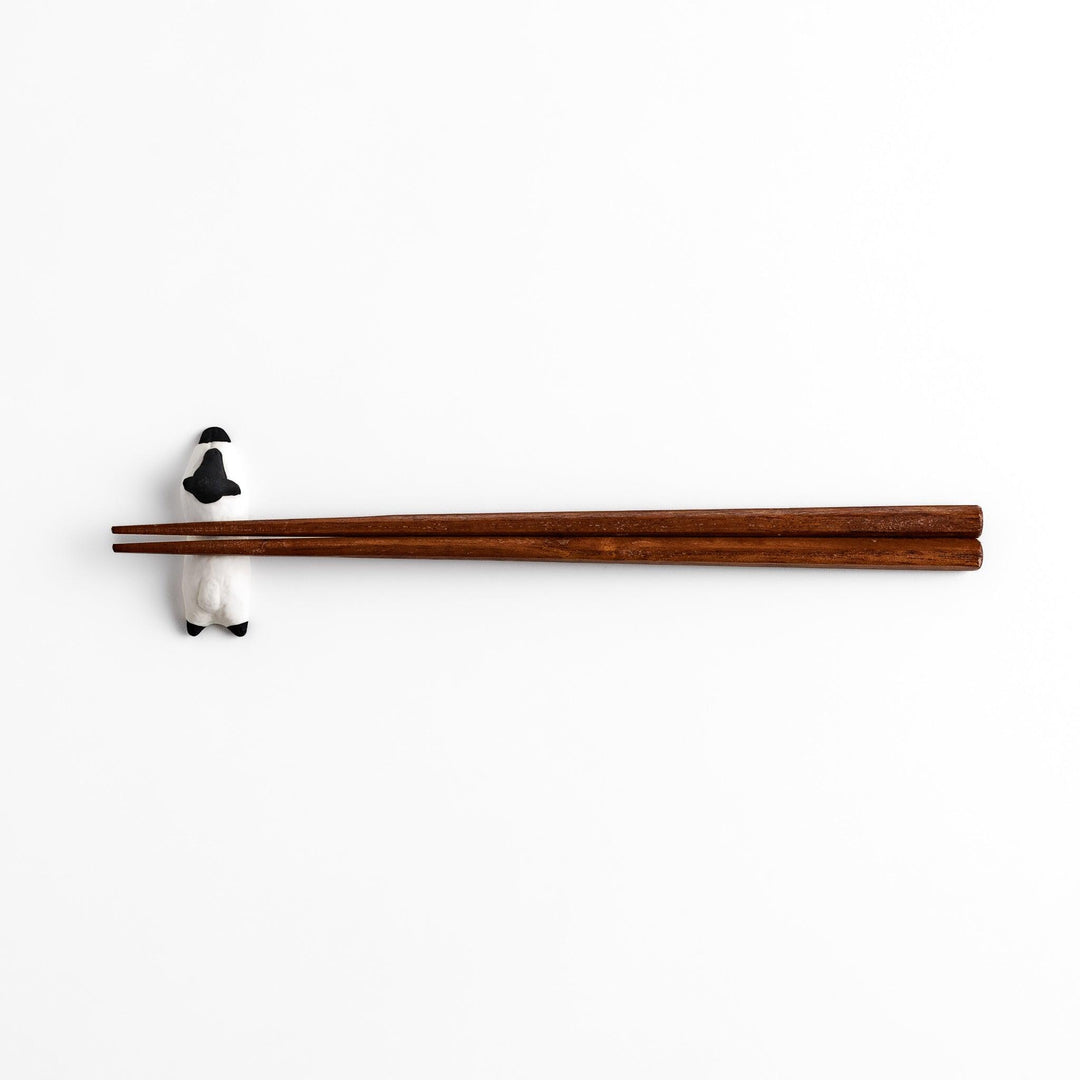 Adorable sleeping sheep chopstick rest, crafted with a minimalist design in black and white, adding a playful and charming touch to your dining table.