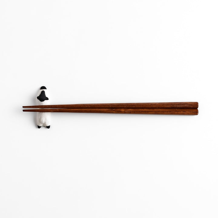 Adorable sleeping sheep chopstick rest, crafted with a minimalist design in black and white, adding a playful and charming touch to your dining table.