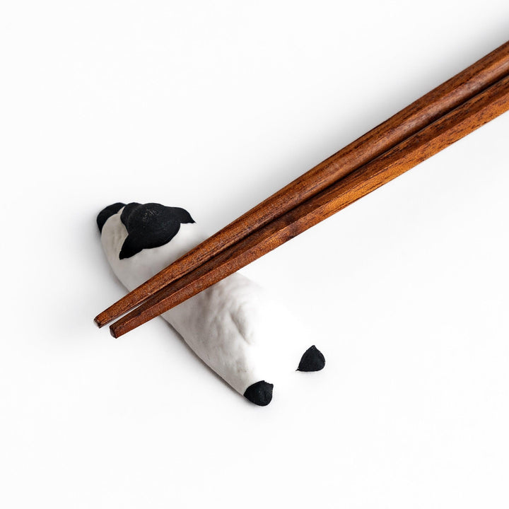 Adorable sleeping sheep chopstick rest, crafted with a minimalist design in black and white, adding a playful and charming touch to your dining table.