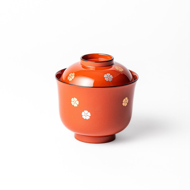 A lidded soup bowl with a warm brown color, adorned with small golden floral patterns.