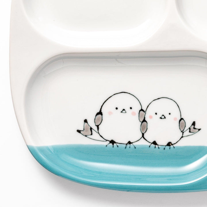 Adorable kids' plate featuring two snowbirds at the bottom and three yellow chicks at the top, with a light blue accent, perfect for brightening up mealtime.