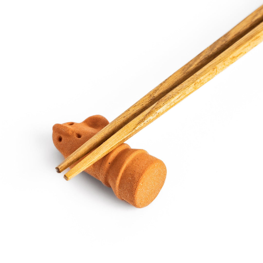 Chopstick rest designed in the shape of a spiritual guardian figure, adding a whimsical and protective touch to your dining table.