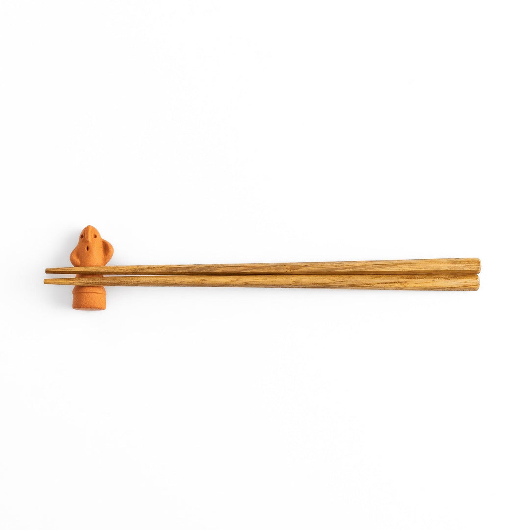 Chopstick rest designed in the shape of a spiritual guardian figure, adding a whimsical and protective touch to your dining table.