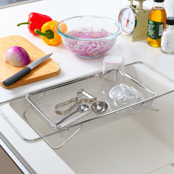 Durable stainless steel draining basket with a fine mesh design, perfect for draining liquids from food during preparation or cooking.