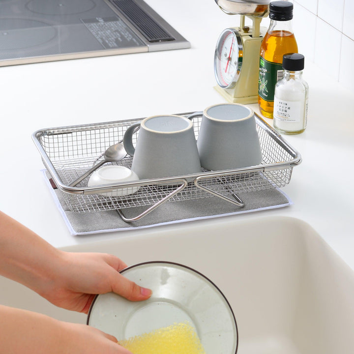 Durable stainless steel draining basket with a fine mesh design, perfect for draining liquids from food during preparation or cooking.