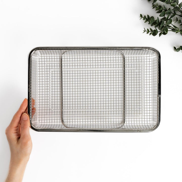 Durable stainless steel draining basket with a fine mesh design, perfect for draining liquids from food during preparation or cooking.