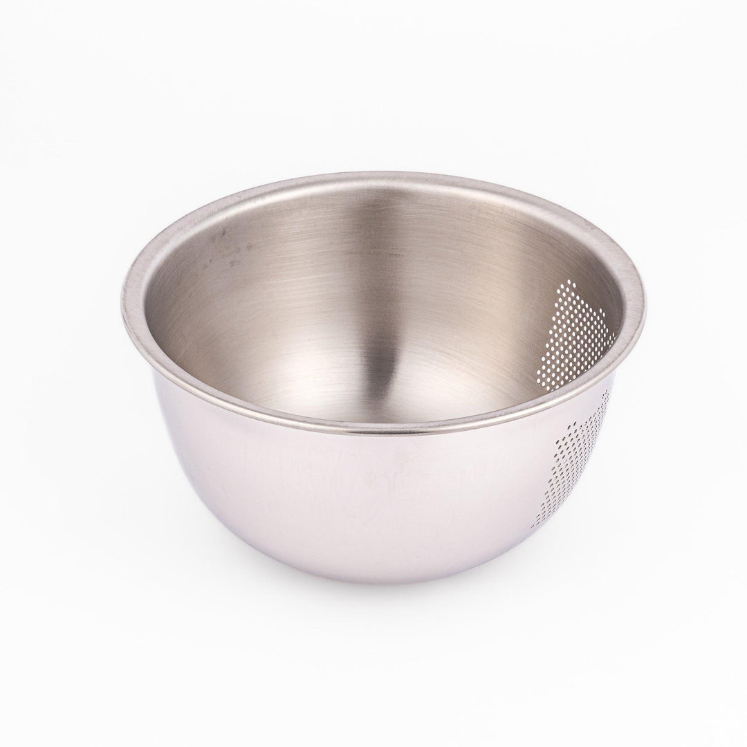 Stainless steel rice washing bowl viewed from above, featuring dual drainage sections—perforated and slotted—for quick, efficient rinsing.