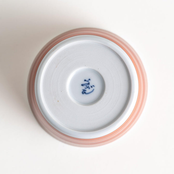 A small condiment bowl with horizontal blue or red stripes of varying shades, creating a minimalist yet elegant design.