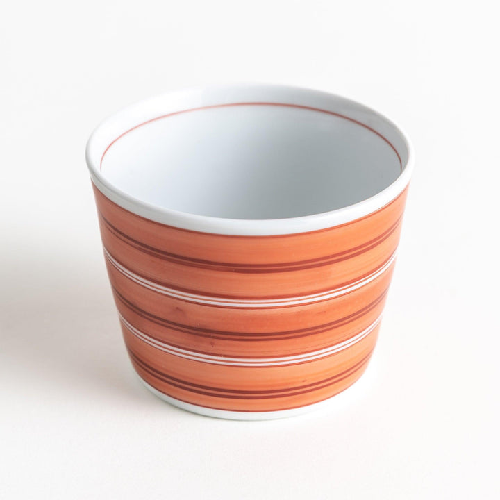 A small condiment bowl with horizontal blue or red stripes of varying shades, creating a minimalist yet elegant design.