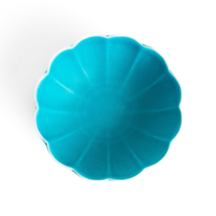 Turkish blue lotus-shaped dessert bowl with a smooth matte finish, featuring intricate petal-like details and a contrasting white base, perfect for serving desserts.