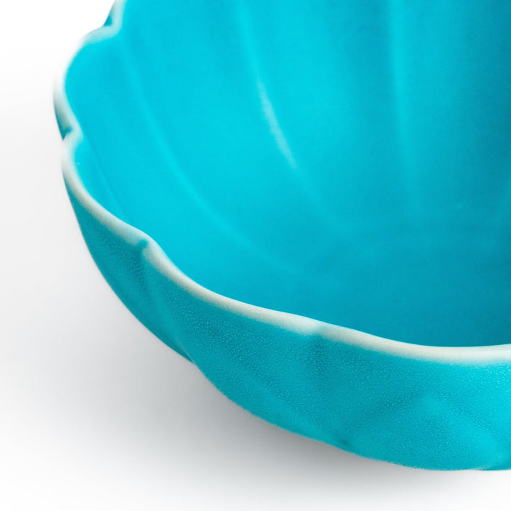 Turkish blue lotus-shaped dessert bowl with a smooth matte finish, featuring intricate petal-like details and a contrasting white base, perfect for serving desserts.