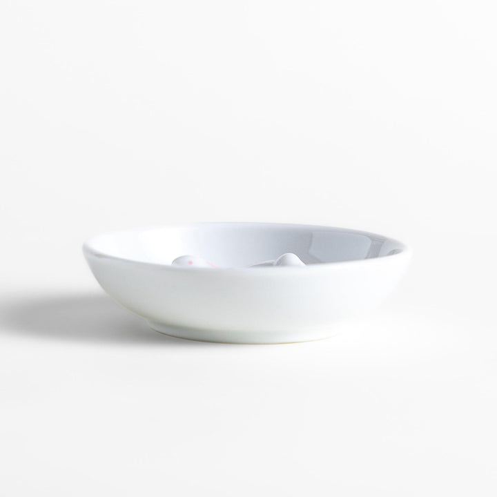 White ceramic incense holder set featuring a round dish and a rabbit-shaped holder with pink accents, designed to catch ash neatly while adding a charming touch.