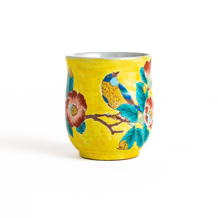 Yellow teacup with a colorful bird perched on a flowering branch, perfect for adding a touch of nature to your tea time.